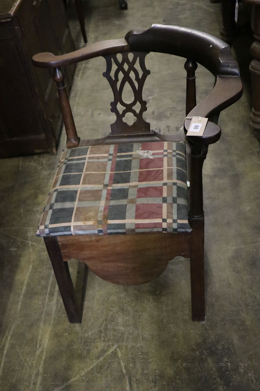 A George III mahogany corner elbow commode chair